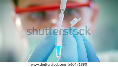 some of the protein test tubes on a sterile container with the ice are taken by a hand with sterile gloves for analysis of proteins and amino acids