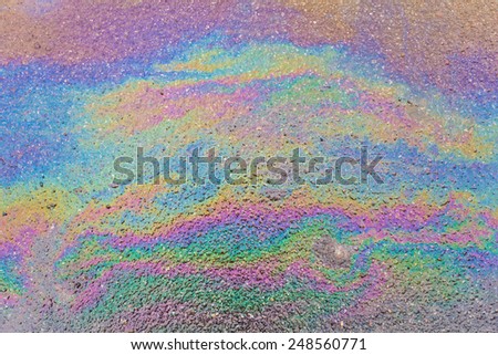 Abstract background of an oil slick on the asphalt