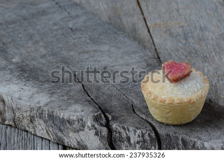 Black Berry Pie Cupcake with Heart and Sugar Topping on Wooden Background