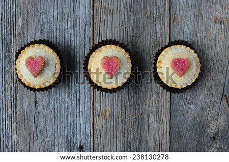 Black Berry Pie Cupcakes with Heart and Sugar Topping on Dark Wood Background