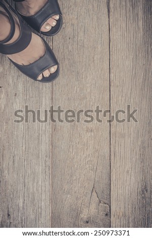 Feet. First-Person view  on rustic wood Floor background.