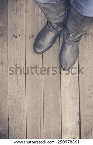 Feet. First-Person view  on rustic wood Floor background.