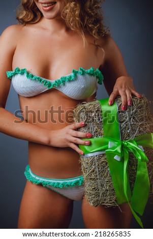 Girl in a bikini with holiday gift. White bikini, caucasian girl.