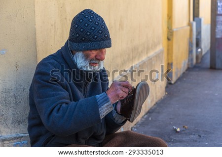 ISTANBUL, TURKEY - APRIL 20: Poor old man shining shoes in the street on April 20, 2015 in Istanbul