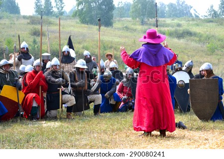 Samara, Russia, the festival of historical reconstruction ancient Russia ages 11-13 - August 16, 2013 - : man in a dress of the 13th century Catholic priest with a pink robe, purple hat blesses
