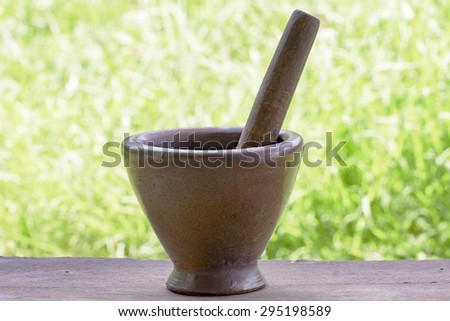 Pestle and mortar made of hard wood Its is device used to prepare ingredients or substances by crushing and grinding.