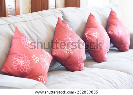 Fabric sofa with red decorative pillows natural