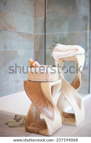 Bathrobes, shampoo and soap on wooden shelves.