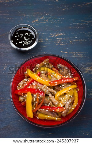 Stir fry pork and vegetables with sesame seeds and soy sauce, asian style, top view