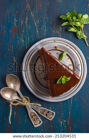 piece of chocolate cake with mint, top view