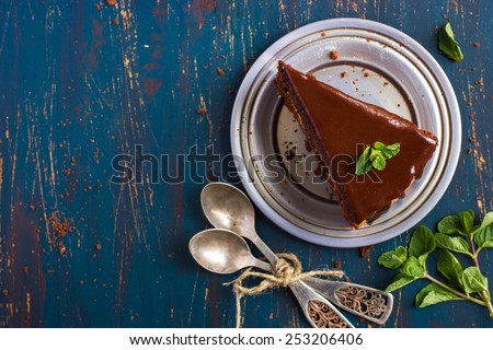 piece of chocolate cake with mint leaves, top view