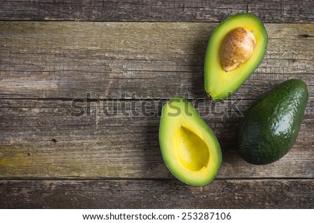 food background with fresh organic avocado on  old wooden table, top view, copy space