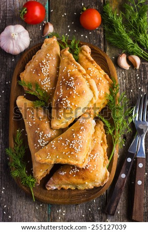 Fresh baked  pasties filled with meat and vegetables, top view
