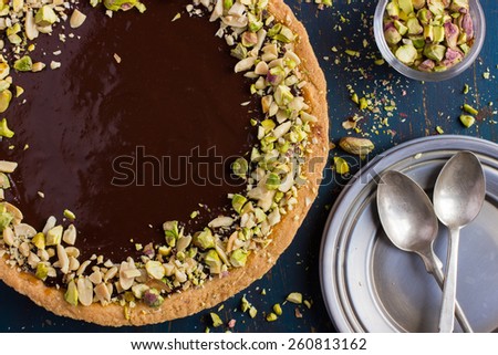 Tart with caramel, chocolate and nuts, top view