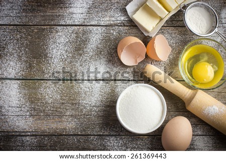 Ingredients for baking on the old wooden table, top view, copy space