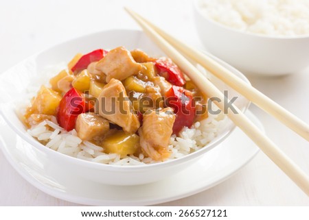Sweet and sour chicken with rice in white bowl