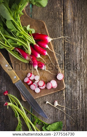 fresh organic radish on wooden cutting board, top view