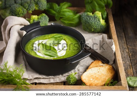 healthy broccoli cream soup on rustic background