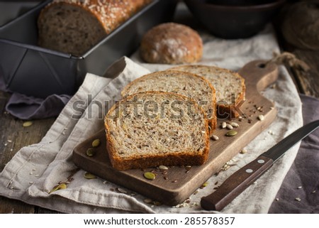 slices of freshly baked  multigrain bread on rustic background