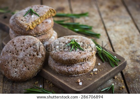 Finnish rye flat bread on rustic background, selective focus