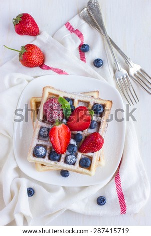 belgian waffles with fresh berries on white background, top view