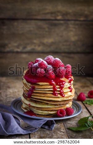 pancakes with fresh raspberry on  rustic background
