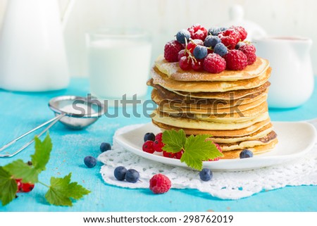 pancakes with fresh summer berries  and powdered sugar
