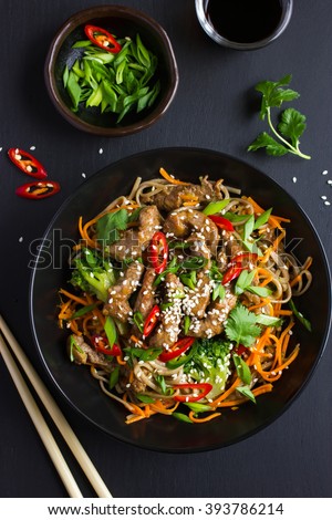 Bowl of soba noodles with beef and vegetables. Asian food. Top view.