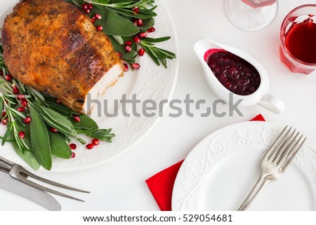 roasted  turkey breast with spicy herbs and cranberry sauce, top view