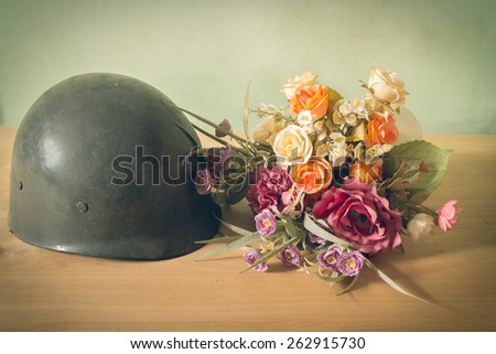 Still life  photography on vintage army helmet and flower