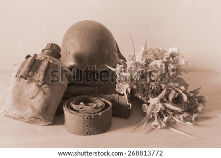 Still life  photography on vintage army helmet and flower