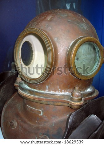 The old diving helmet lays on a shelf.