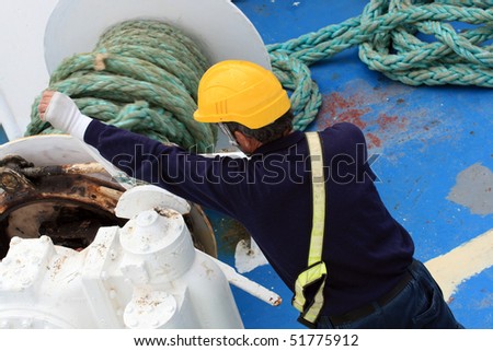 crew member manning the anchor of a ship