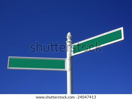 Blank street sign against a blue sky