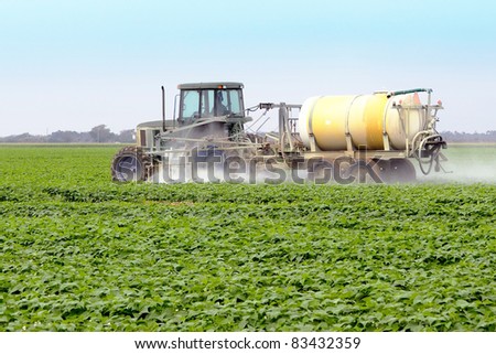 The application of pesticides on a commercial agricultural field with Yellow Squash