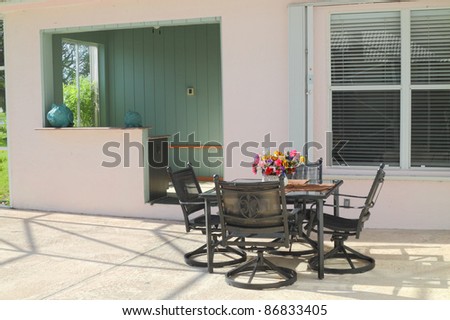 Beautiful residential  patio with furniture and a bar