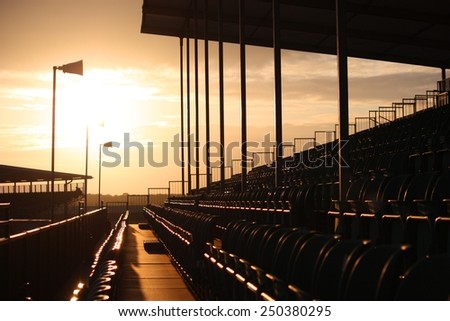 Symmetrical regular pattern grandstand seating arrangement at sunset