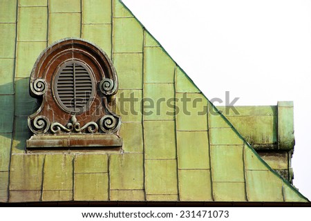 Mansard windows on an ancient green roof