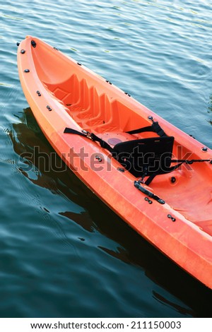 red kayak on dark water