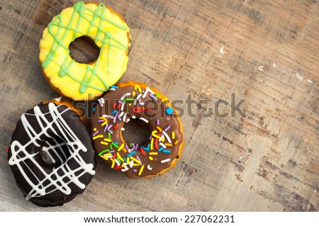 bright donuts on wooden background.