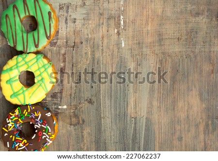 bright donuts on wooden background.