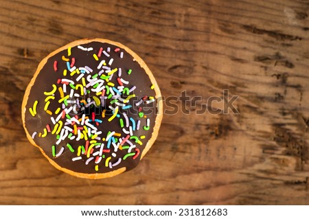 Bright donut on wooden background.