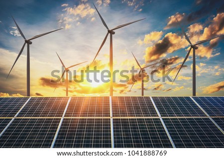 wind turbine with solar panels and sunset. concept clean energy