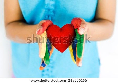 little girl and red heart on two hand