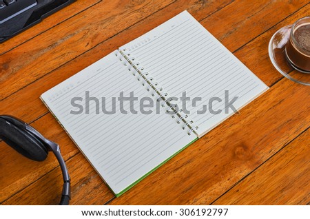 Open a blank white notebook and cup of coffee on the desk