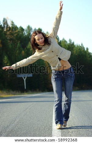 Girl balance on the road in forest