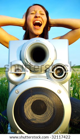 Young woman going crazy about loud music