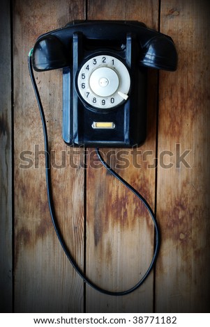 Retro phone on a wooden wall