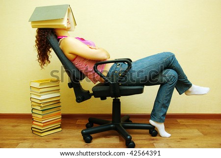 Sleeping female student with book on head