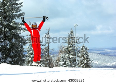 Happy woman in skiing clothes in winter landscape with place for text